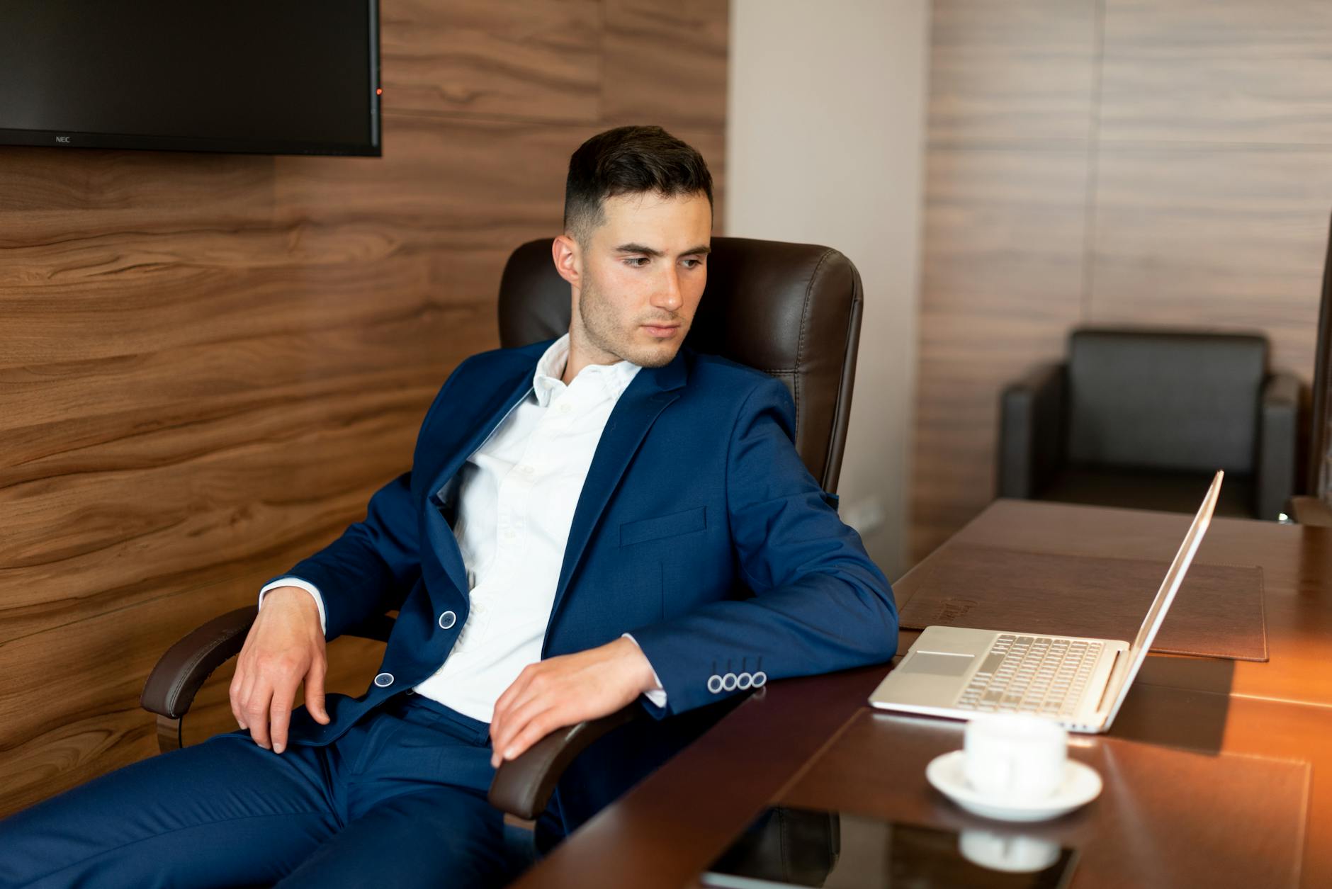 Financial planner at desk in modern office with laptop